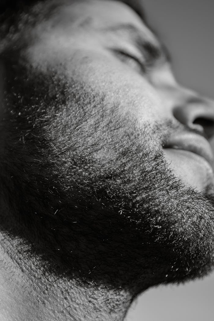 home-hero Detailed black and white close-up of a bearded man, emphasizing texture and contrast.